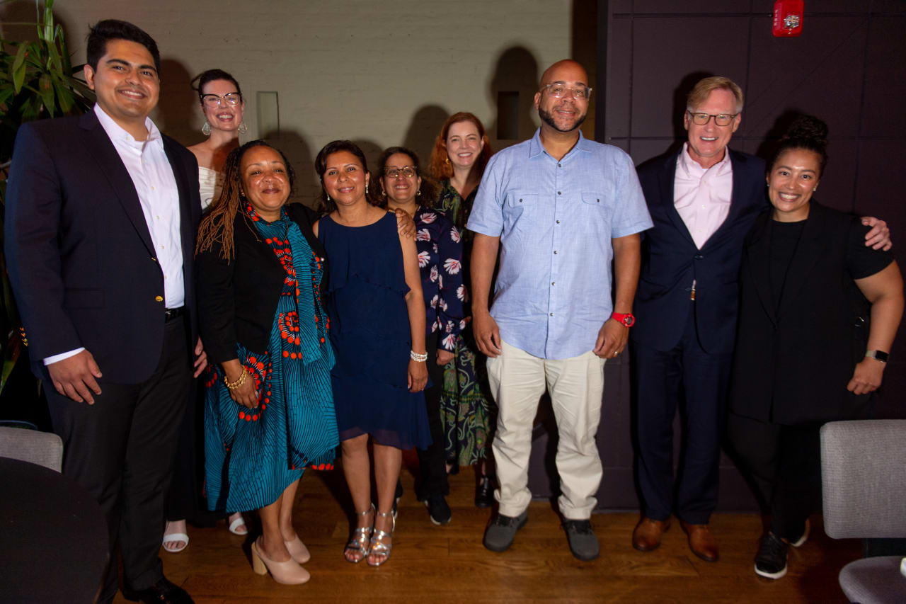 Front Row (L to R): Hiram Cortez, Regine Elie, Ana Quijada, Mazi Mutafa, Jeffrey Johnson, Shanell Mosley  Second Row (L to R): Christine Steffens, Karen George, Donna Adams